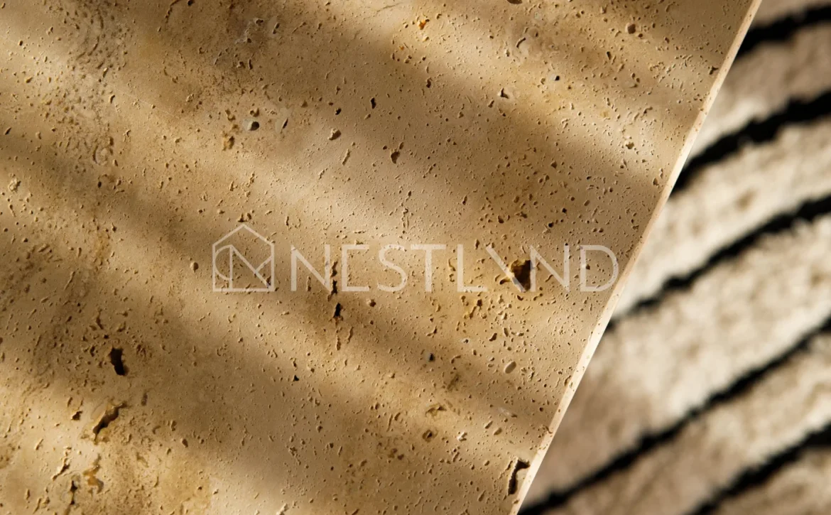 Close-up of wooden coffee table on a rug, in soft lighting.
