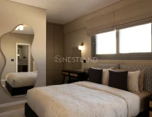 Elegant bedroom with a large bed, unique mirror, window, and stylish decor.