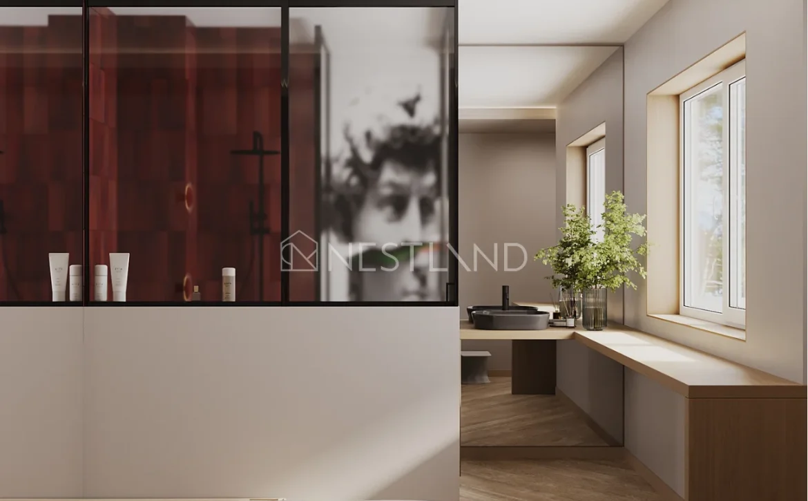 A modern bedroom with a red wardrobe, a blurry artwork, and a window-side vanity.