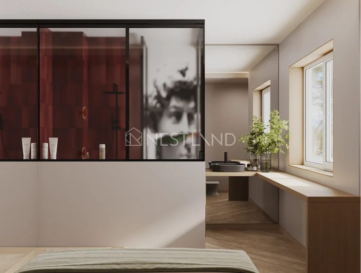 A modern bedroom with a red wardrobe, a blurry artwork, and a window-side vanity.