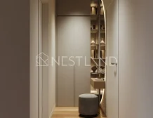 Modern hallway with herringbone wood flooring, built-in cabinets, and a cozy nook with a shelf and stool.