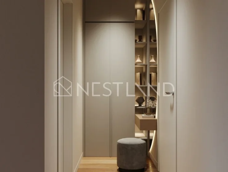 Modern hallway with herringbone wood flooring, built-in cabinets, and a cozy nook with a shelf and stool.