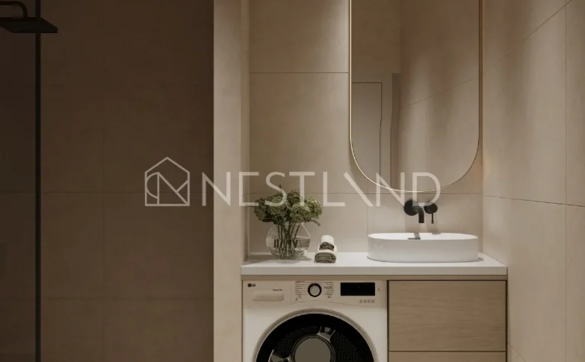 Modern bathroom with integrated laundry area featuring a washing machine and a stylish basin under a mirror.