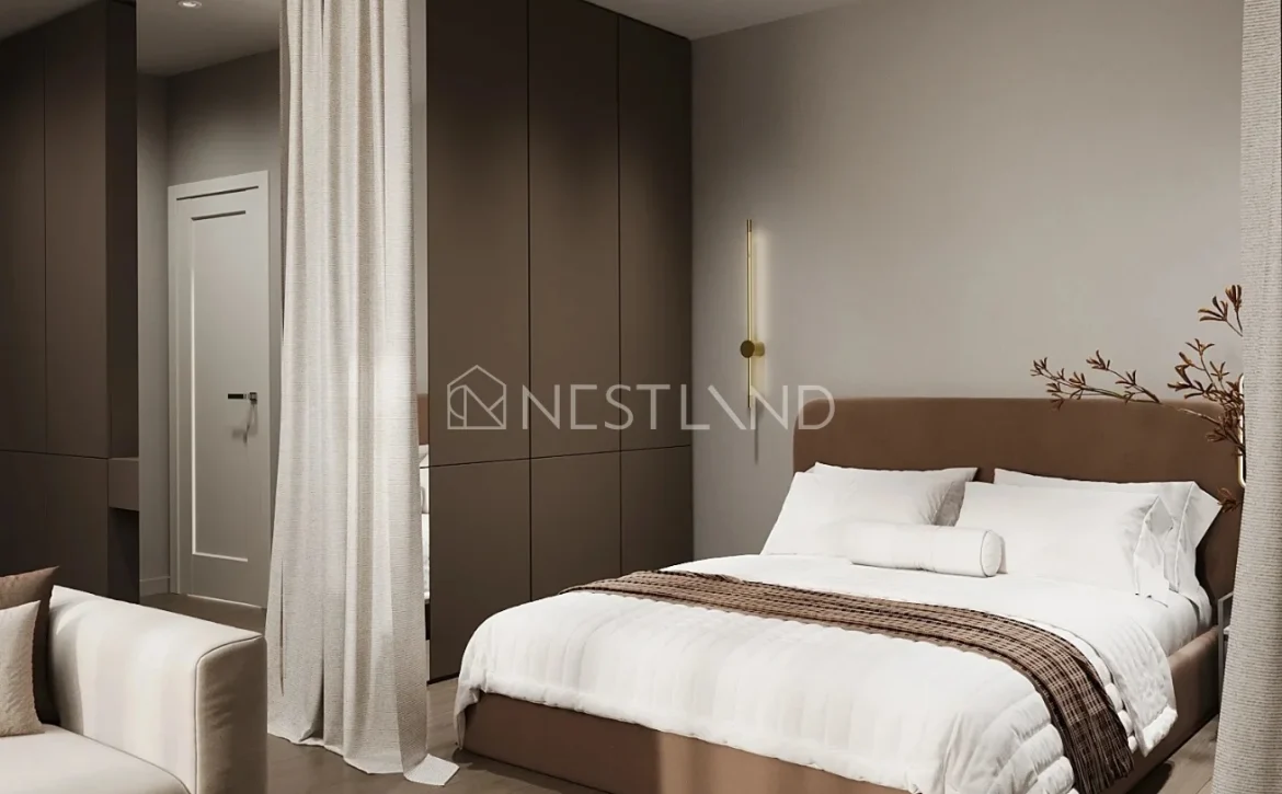 Modern bedroom with a beige upholstered bed, white bedding, brown accents, and minimalist decor.