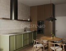 Modern kitchen with green cabinets, gray countertops, black appliances, and a round wooden dining table with four chairs.